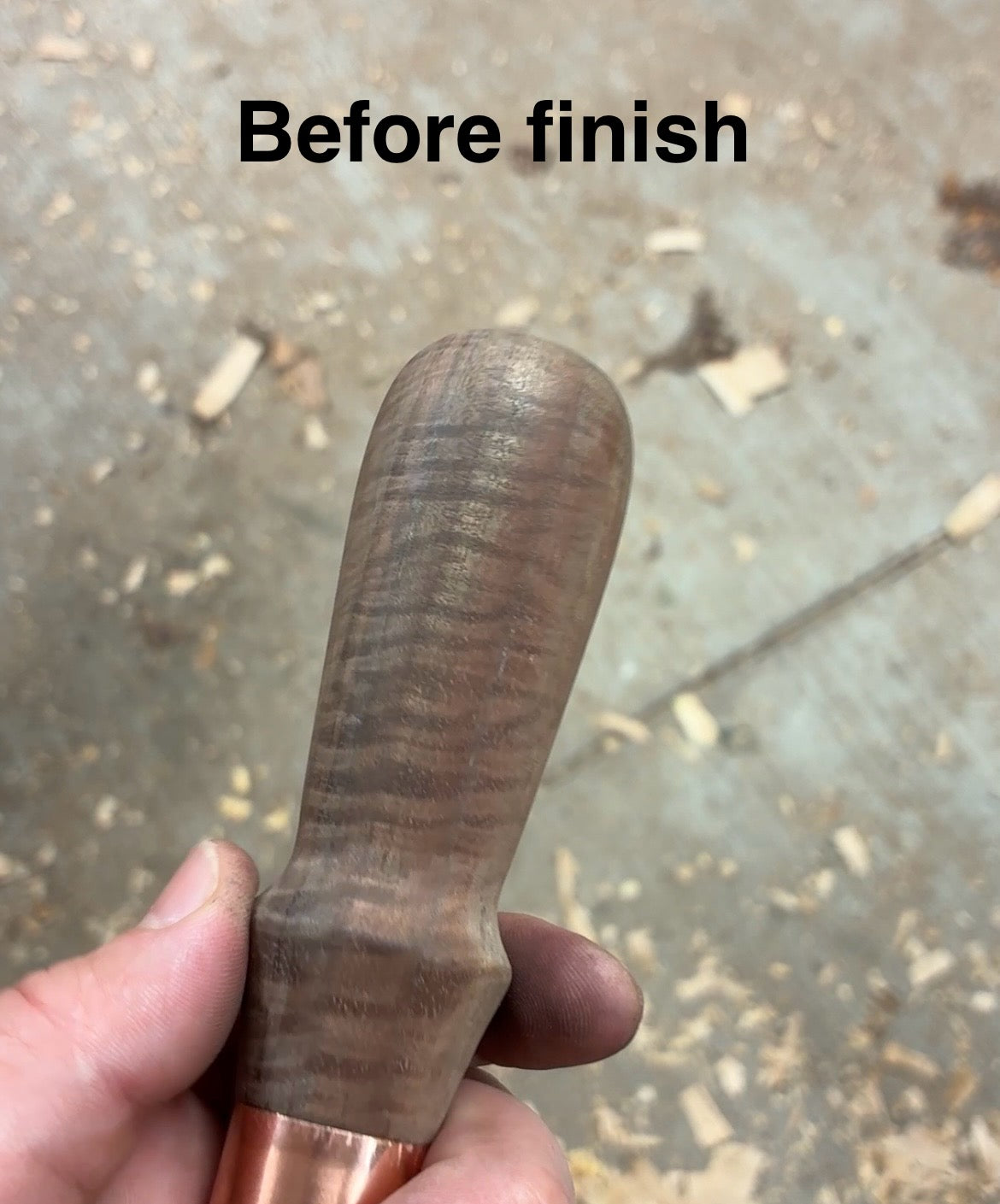 Wooden handle Before finish held by a hand